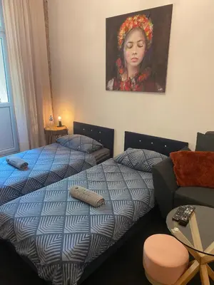 a bedroom with a bed and a portrait of a woman at Topolove Rooms & Apartments in Kraków