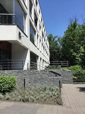 a building with a staircase in front of a building at Apartment Novum Rakowicka Street in Kraków