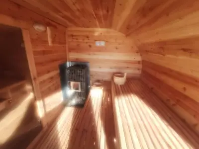 an inside view of a log cabin with a fireplace at Domki Zagroda Domek z bala z basenem & sauna & balia z hydromasażem in Słopnice