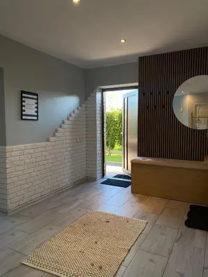 a living room with a staircase and a mirror at Apartament U Grazi in Spytkowice