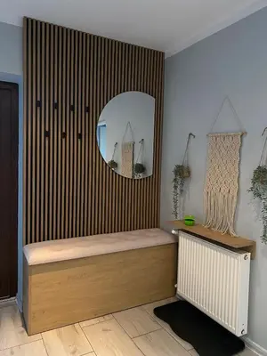 a room with a bed and a mirror on the wall at Apartament U Grazi in Spytkowice