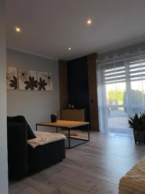a living room with a couch and a table at Apartament U Grazi in Spytkowice