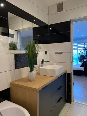 a bathroom with a sink and a toilet and a mirror at Apartament U Grazi in Spytkowice