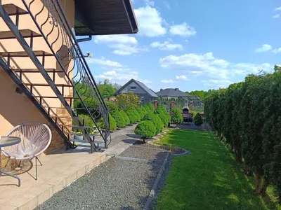 a backyard with a garden of bushes and trees at Apartament U Grazi in Spytkowice