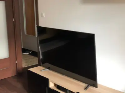a large flat screen tv sitting on a entertainment center at Cystersów 10 by Atrium Apartments in Kraków