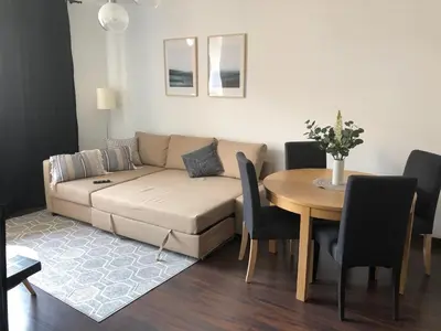 a living room with a couch and a table at Cystersów 10 by Atrium Apartments in Kraków