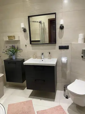 a bathroom with a sink and a toilet and a mirror at Cystersów 10 by Atrium Apartments in Kraków