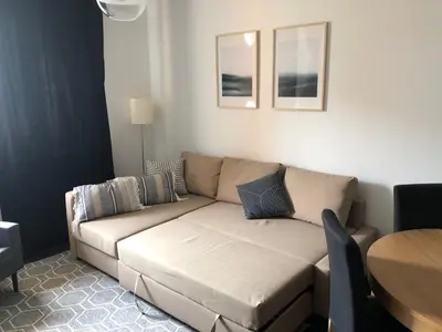 a living room with a couch and a table at Cystersów 10 by Atrium Apartments in Kraków