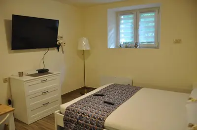 a bedroom with a bed and a flat screen tv at Wenecja 4A by Homeprime in Kraków