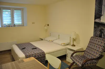 a bedroom with a bed and a chair and a window at Wenecja 4A by Homeprime in Kraków
