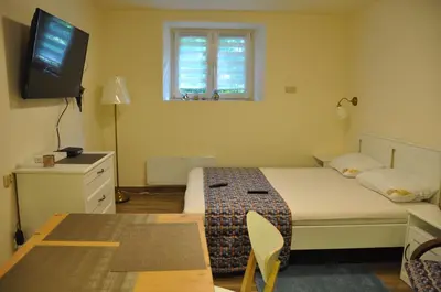 a small room with a bed and a television at Wenecja 4A by Homeprime in Kraków