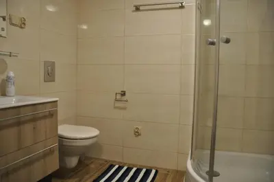 a bathroom with a toilet a sink and a shower at Wenecja 4A by Homeprime in Kraków