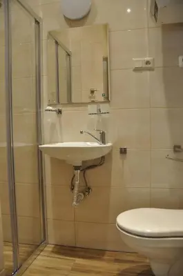 a bathroom with a sink and a toilet at Wenecja 4A by Homeprime in Kraków