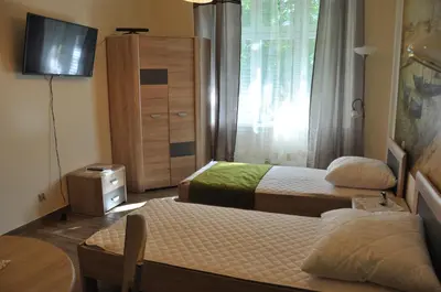 a small bedroom with two beds and a dresser at Wenecja 4A by Homeprime in Kraków