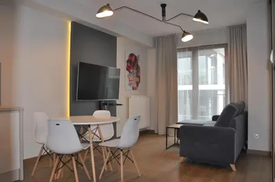a living room with a table and a couch at Rakowicka 22J (B) by Homeprime in Kraków