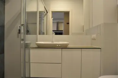 a bathroom with a sink and a mirror at Rakowicka 22J (B) by Homeprime in Kraków