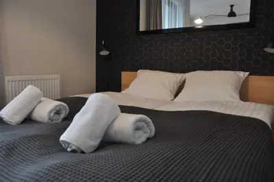 a bedroom with a large bed with towels on it at Rakowicka 22J (B) by Homeprime in Kraków