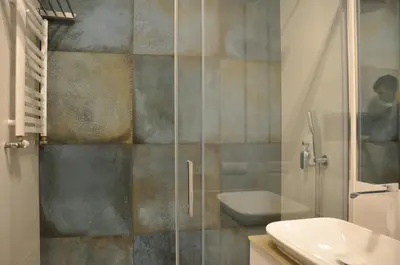 a bathroom with a shower with a toilet and a sink at Rakowicka 22J (B) by Homeprime in Kraków