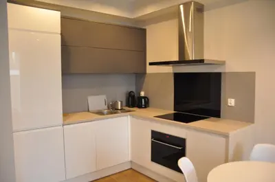 a kitchen with white cabinets and a stove top oven at Rakowicka 22J (B) by Homeprime in Kraków
