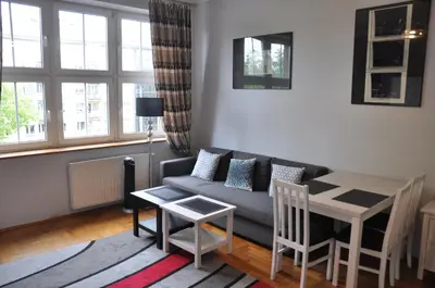 a living room with a couch and a table at aleja Krasińskiego 30 by Homeprime in Kraków
