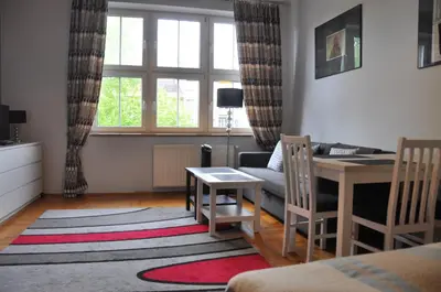 a small living room with a table and a couch at aleja Krasińskiego 30 by Homeprime in Kraków