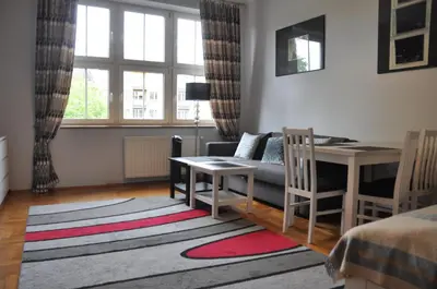 a living room with a couch and a table and a desk at aleja Krasińskiego 30 by Homeprime in Kraków