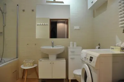a bathroom with a sink and a toilet and a mirror at aleja Krasińskiego 30 by Homeprime in Kraków