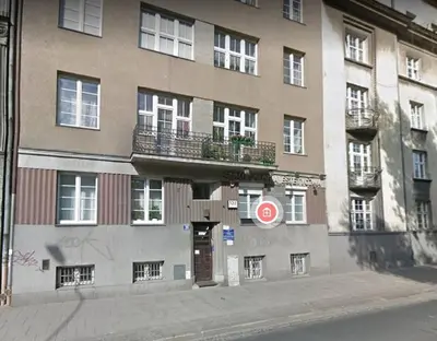 a building on a city street with a sign on it at aleja Krasińskiego 30 by Homeprime in Kraków