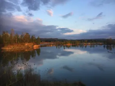 a view of a large lake at sunset at Dom Pod Orzechem in Łapczyca