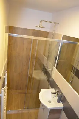 a bathroom with a shower and a sink at Kolorowy Domek in Kasina Wielka
