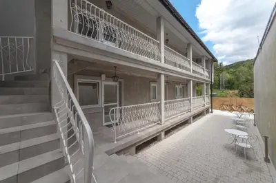 a balcony of a building with stairs and tables at Boleslav Home in Sucha Beskidzka