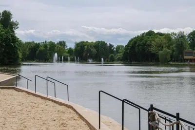 a person standing on a beach near a body of water at THE HEART OF NOWA HUTA - free garage in Kraków