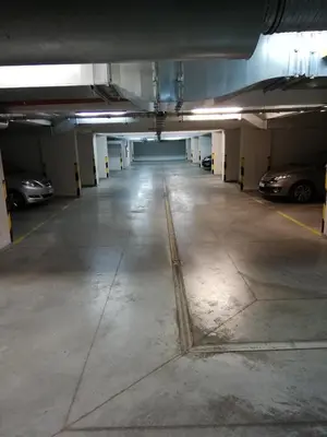 an empty parking garage with cars parked in it at THE HEART OF NOWA HUTA - free garage in Kraków