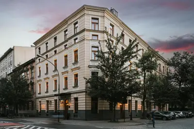a large white building on a city street at Hotel Wawel Queen in Kraków