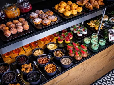a display case filled with lots of different types of food at Hotel Wawel Queen in Kraków