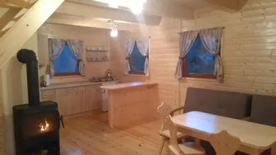 a kitchen with a stove and a table in a room at Ranczo Zapole in Zasadne