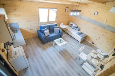 an overhead view of a living room with a blue couch at FamilyCamp in Zator