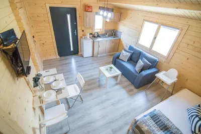 a living room with a couch and a table at FamilyCamp in Zator