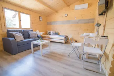 a living room with a couch and a table at FamilyCamp in Zator