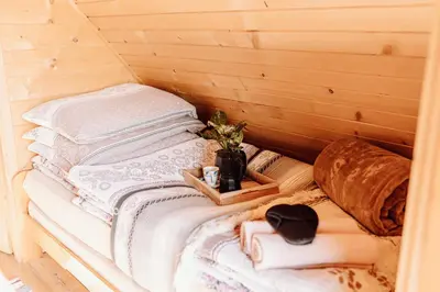 a sauna with a stack of blankets and towels at Domek na uboczu in Klikuszowa