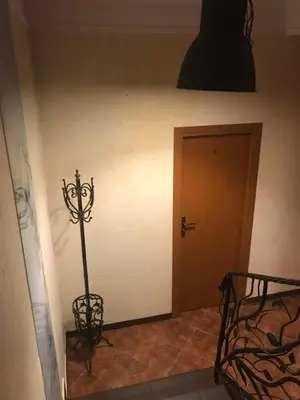 a hallway with a room with a door and a lamp at Piwnica in Miechów