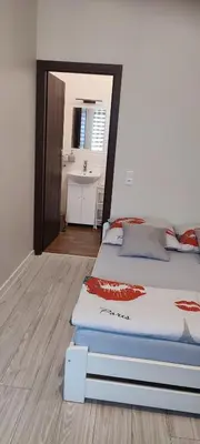 a bedroom with a bed and a bathroom with a sink at Torino in Zator