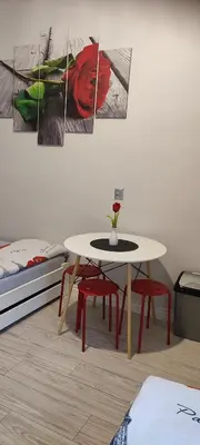 a table and chairs in a room next to a bed at Torino in Zator