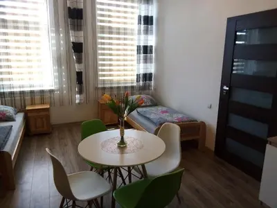 a small room with a table and chairs and a bed at Torino in Zator