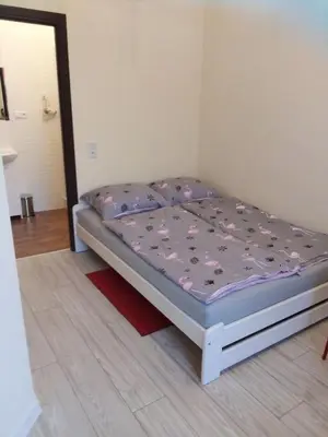 a bed in a room with a purple mattress at Torino in Zator
