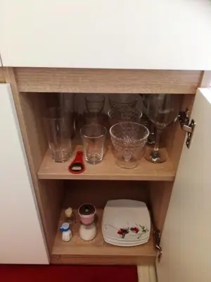 a shelf with glasses and other items on it at Torino in Zator