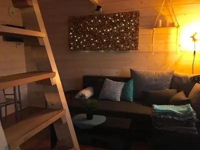 a living room with a couch and a ladder at Brzozowy Gaj in Bachowice