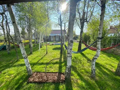 a hammock hanging between two trees in a park at Brzozowy Gaj in Bachowice