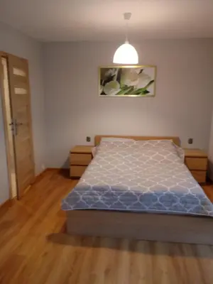 a bedroom with a bed and a pendant light at Agroturystyka u Krzysztofa ZATOR ,ENERGYLANDIA , NOCLEGI in Graboszyce