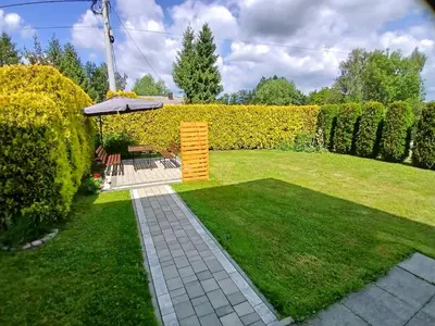 a garden with a bench and a gazebo at Agroturystyka u Krzysztofa ZATOR ,ENERGYLANDIA , NOCLEGI in Graboszyce